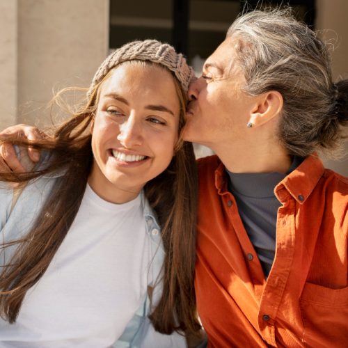 medium-shot-mother-kissing-daughter-head